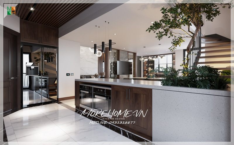 Thiết kế bàn đảo bếp với mặt đá nhân tạo kết hợp với tủ gỗ tự nhiên giúp phân chia khu vực bếp với phòng khách một cách tự nhiên